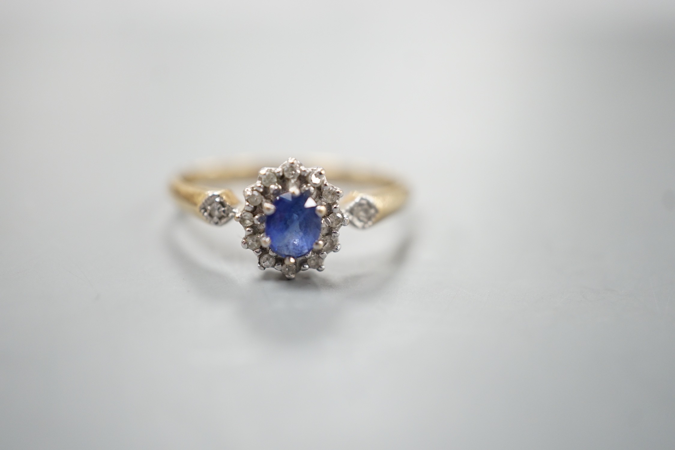 A modern 9ct gold, sapphire and diamond set cluster ring, size R, gross 2.3 grams.